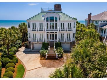 Stunning three-story beachfront home boasting an amazing top-level deck, manicured landscaping, and private beach access at 100 Ocean Park Loop, Georgetown, SC 29440