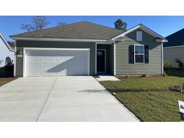 Charming single-story home featuring a one-car garage, manicured lawn, and traditional siding in a neutral color palette at 156 Dagger Ct., Myrtle Beach, SC 29588