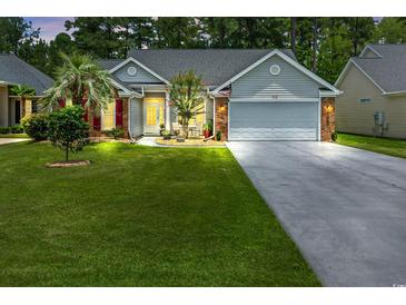 Charming home with a well-manicured lawn, gray siding, brick accents, and a two car garage at 183 Glenwood Dr., Conway, SC 29526