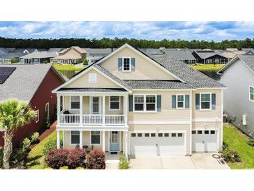 Charming home with a two-car garage, light siding, blue shutters, and a second-story balcony at 6186 Chadderton Circle, Myrtle Beach, SC 29579