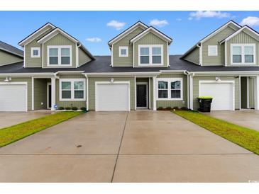 Inviting townhome featuring a one-car garage and well-maintained green space at 623 Harrison Mill St. # 623, Myrtle Beach, SC 29579