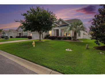 Charming single-story home featuring lush green lawn, mature trees, and vinyl siding at 632 Lafayette Park Dr., Little River, SC 29566