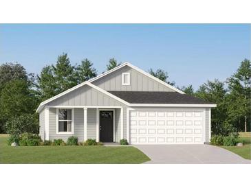 Charming single-story home with gray siding, white trim, and a well-manicured lawn showcasing modern curb appeal at 6366 Swainson Street Sw, Ocean Isle Beach, NC 28469