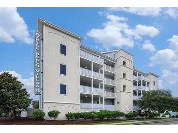 Three story condo with balconies and manicured landscaping with plenty of curb appeal at 704 S Ocean Blvd. # 304A, Myrtle Beach, SC 29577