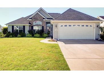 Charming home featuring a well-manicured lawn and attached two-car garage in a desirable neighborhood at 708 Shenanigan Loop, Murrells Inlet, SC 29576