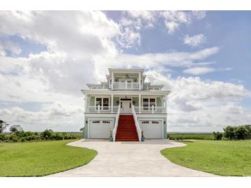 Beautiful two-story home with a double garage, red stairway, and white railings at 125 Oak Bay Dr., Georgetown, SC 29440