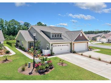 Beautiful single-Gathering home with a two-car garage, manicured lawn, and inviting curb appeal at 204 Kinross Ct., Little River, SC 29566