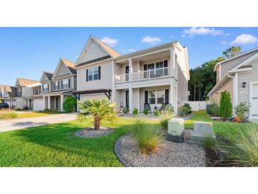 Charming two-story home with landscaped yard and a cozy front porch, perfect for enjoying the neighborhood views at 226 Calhoun Falls Dr., Myrtle Beach, SC 29579