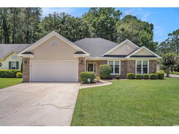 Charming single-story home with brick accents, manicured lawn, and two-car garage on a sunny day at 2510 Oriole Dr., Murrells Inlet, SC 29576