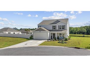 Charming two-story home featuring a well-maintained lawn, two car garage, and landscaped front yard at 417 Spruce Pine Way, Conway, SC 29526