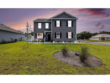 Charming two-story home with gray siding, black shutters and manicured front yard at 651 Choctaw Dr., Conway, SC 29526