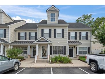 Inviting townhome with classic black shutters and covered front porch at 108 Barnacle Ln. # 4, Little River, SC 29566
