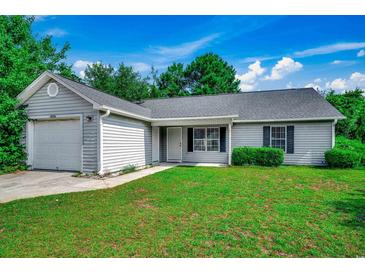 Charming single-story home with gray siding, well-maintained lawn, and attached one car garage at 1836 Juniper Dr., Conway, SC 29527