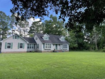 Charming one-story home featuring a well-manicured lawn and classic green shutters at 1872 Harris Short Cut Rd., Conway, SC 29526