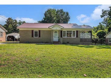Charming single-story home with a well-manicured lawn and inviting front porch at 320 Edgewood Circle, Conway, SC 29527