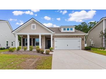 Inviting single-story home with a two-car garage, charming columns, and a well-manicured lawn at 3217 Shadow Pine Ct., Myrtle Beach, SC 29579