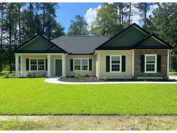 Charming single-story home showcasing a manicured lawn and inviting curb appeal at 5310 Pauley Swamp Rd., Conway, SC 29527