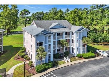 Beautiful condominium with multiple floors and balconies, complemented by lush landscaping and a convenient parking area at 605 Waterway Village Blvd. # 31A, Myrtle Beach, SC 29579