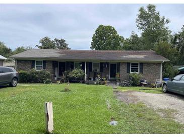 Charming brick duplex featuring a well-maintained lawn and inviting curb appeal at 719 11Th Ave. S, Myrtle Beach, SC 29577