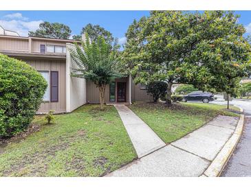 Charming exterior of a well-maintained home with mature trees and a walkway to the front door at 800 Egret Circle # 53, Little River, SC 29566