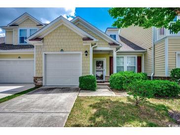 Charming two-story home featuring a one car garage and well-maintained landscaping at 100 Culpepper Way # 1002, Myrtle Beach, SC 29579