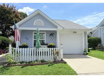 Charming single-story home with a white picket fence, inviting porch, and well-maintained lawn at 110 Cambridge Circle, Myrtle Beach, SC 29577