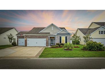 Charming single-story home featuring brick accents, manicured lawn, and a two-car garage at 138 Copper Leaf Dr., Myrtle Beach, SC 29588