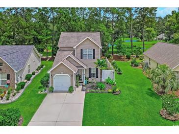 Well-maintained two-story home with attached garage, beautiful landscaping, and lush green lawn in a desirable neighborhood at 161 Barclay Dr., Myrtle Beach, SC 29579