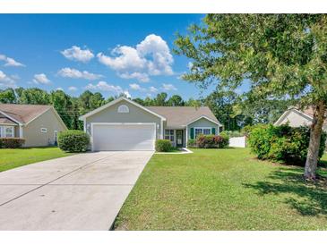 Charming single-story home with a well-manicured lawn and attached two-car garage at 219 Blackpepper Loop, Little River, SC 29566