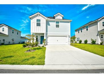 Charming two-story home with a manicured lawn and a two-car garage at 2325 Copper Creek Loop, Longs, SC 29568