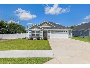 Charming home with a two-car garage, well-manicured lawn, and inviting curb appeal at 2599 Woodcreek Ln., Conway, SC 29527