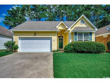 Charming yellow single-story home with a well-manicured lawn, attached garage, and inviting curb appeal at 2602 Clearwater St., Myrtle Beach, SC 29579