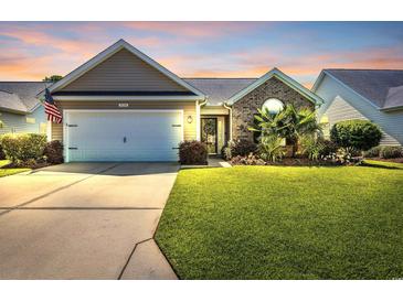 Charming single-story home with a well-manicured lawn, landscaped garden, and attached two-car garage at 3154 Shorecrest Bay Dr., Murrells Inlet, SC 29576