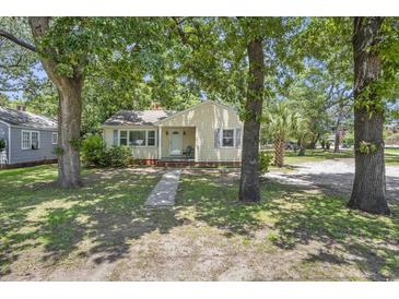 Charming single-story home with a lush, tree-filled front yard and inviting curb appeal at 602 3Rd Ave. N, Myrtle Beach, SC 29577