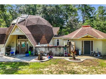 Unique dome home exterior with inviting patio and lush greenery at 10381 Hardwick Rd., Nichols, SC 29581