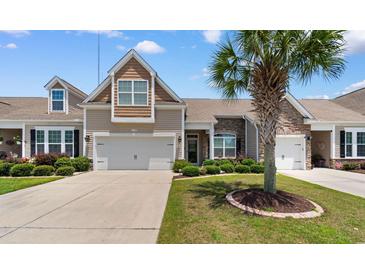 Charming two-story home with a tan exterior, stone accents, landscaped yard, and a spacious two-car garage at 178 Parmalee Dr. # C, Murrells Inlet, SC 29576