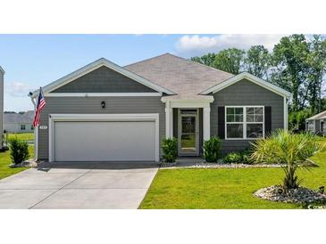 Charming one-story home with manicured lawn, attached garage, and inviting curb appeal at 305 Forestbrook Cove Circle, Myrtle Beach, SC 29588