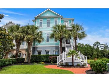 Beautiful three-story beach house with striking blue exterior and palm trees at 350 Saint Julian Ln., Myrtle Beach, SC 29579
