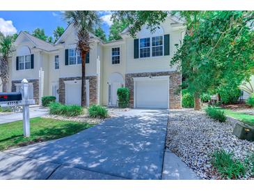 Charming townhome with stone accents, attached garage, well-kept lawn and mature trees at 4355 Rivergate Ln. # F, Little River, SC 29566