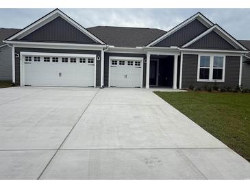 Charming home with a large driveway leading to a three-car garage at 528 Oak Landing Dr., Myrtle Beach, SC 29588