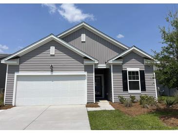 Charming single-story home with gray siding, white trim, and an attached two-car garage with manicured front lawn at 606 Muster Field Ct., Conway, SC 29526