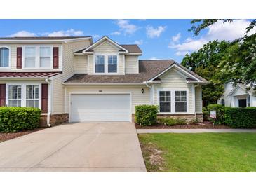 Charming two-story home features a white garage door, nicely landscaped yard, and light yellow siding at 6095 Catalina Dr. # 616, North Myrtle Beach, SC 29582