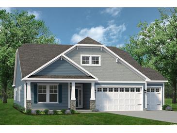 Charming single-Gathering home with a two-car garage, a welcoming front porch, and a beautifully landscaped yard at 719 St. Vincent Loop, Little River, SC 29566