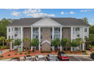 Charming condo building with a manicured landscape, providing an inviting curb appeal at 124 Birch N Coppice Dr. # 1, Surfside Beach, SC 29575