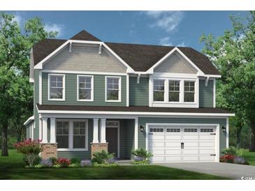 Charming two-story home featuring a welcoming front porch, complemented by an attached two-car garage at 1247 Halter Pl., Calabash, NC 28467