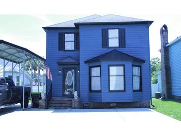Charming blue two-story home with an American flag and manicured landscaping at 1557 Elizabeth Rd., Myrtle Beach, SC 29577