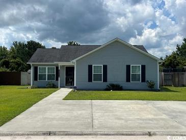 Charming single-story home with a well-manicured lawn, gray siding and dark shutters at 298 Weyburn St., Myrtle Beach, SC 29579