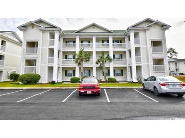 Charming multi-story condo building with white siding, balconies, and well-maintained landscaping at 510 White River Dr. # 24G, Myrtle Beach, SC 29579