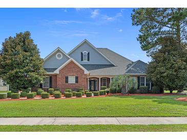 Charming home boasts well-manicured lawn, mature trees, and tasteful landscaping at 904 Kalmia Ct., Myrtle Beach, SC 29579