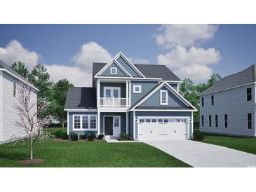 Charming two-story home featuring blue siding, white trim, and a welcoming two-car garage at 1088 Laconic Dr., Myrtle Beach, SC 29588